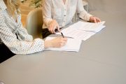 Recession proof your income: Two women at a table reviewing a resume